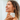 Woman holding a 'Honor' skincare product with a neutral background lavender